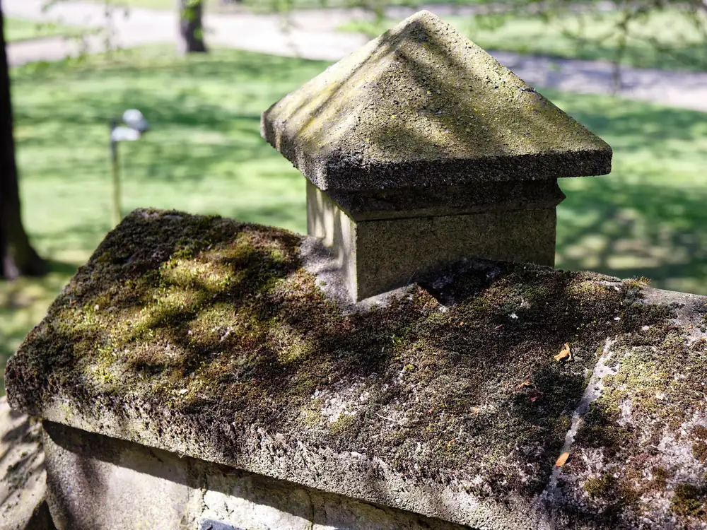 A weathered stone coping on a parapet