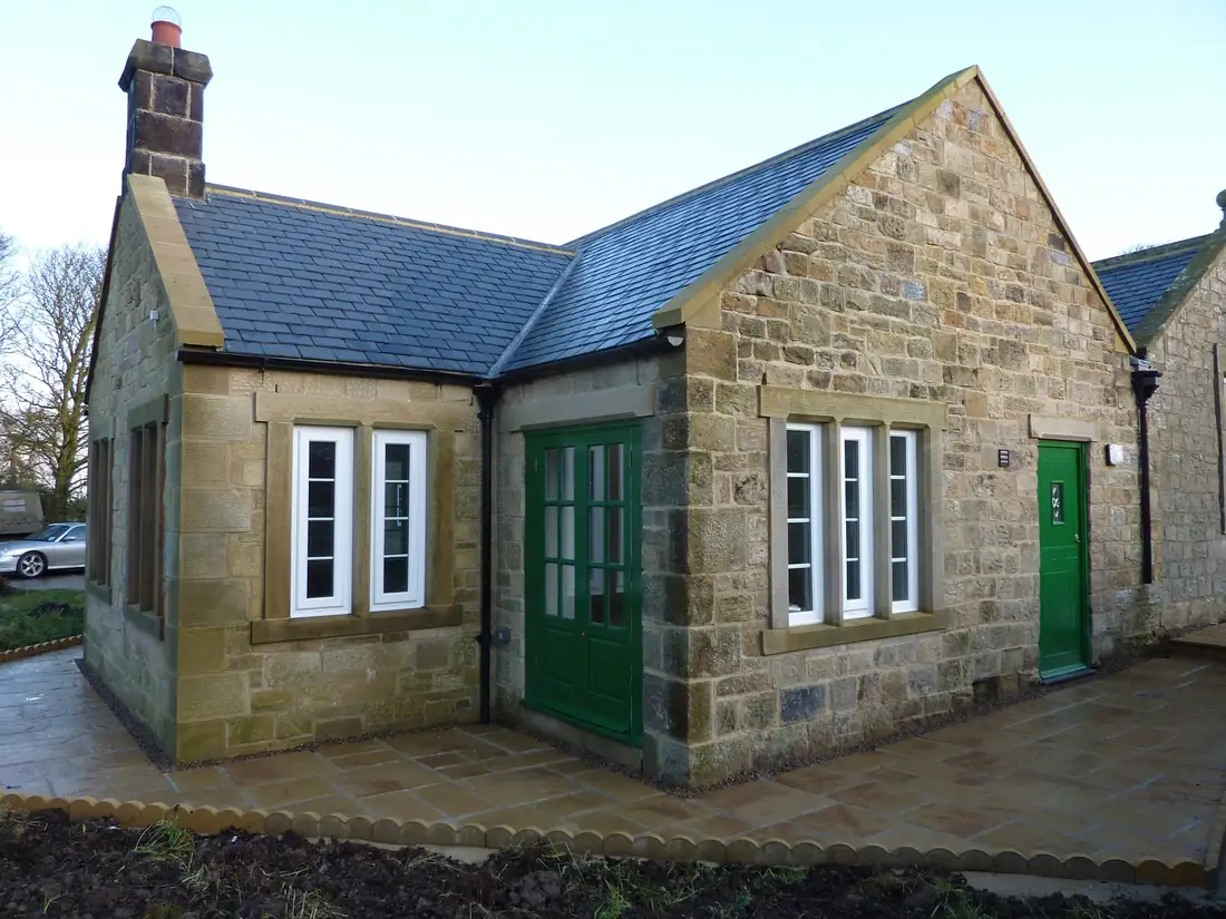 A York stone house with stone sills and heads to the windows
