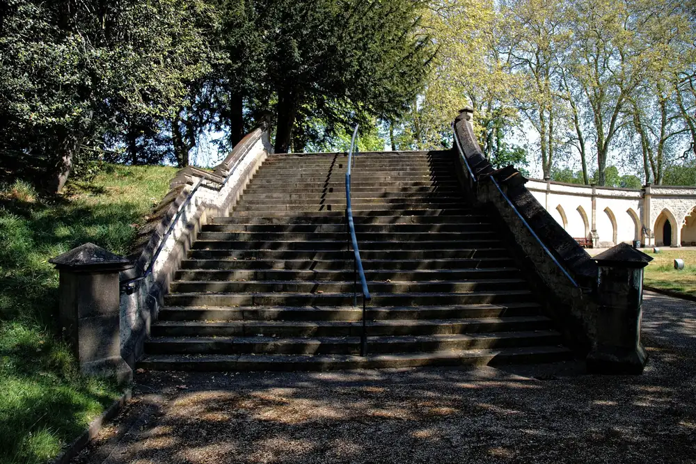 A wide flight of stone steps with coped side walls